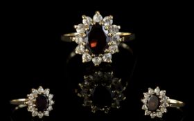 A Vintage 9ct Gold Attractive Garnet And Diamond Set Cluster Ring. Flower head design.