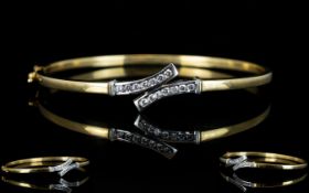 Ladies 9ct Gold Hinged Bangle Set with 14 Diamonds of Good Colour and Clarity. Est Diamond Weight 0.