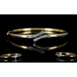 Ladies 9ct Gold Hinged Bangle Set with 14 Diamonds of Good Colour and Clarity. Est Diamond Weight 0.