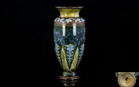 A Small Doulton Lambeth Vase Footed vase in mottled green glaze with art nouveau floral decoration,