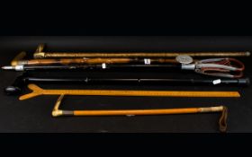 A Collection Of Canes And Sticks To include shooting sticks, riding crop, measure,