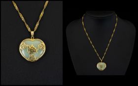 A Chinese Style Jadeite Stone Heart Shaped Pendant In 9ct Gold Mount Suspended On A 16 Inch 9ct
