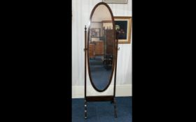 An Early 20thC Free Standing Bedroom Mahogany Framed Cheval Mirror of elegant oval form.