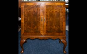 Walnut Side Cabinet two door single shelf and small drawer. Raised on short cabriole legs.