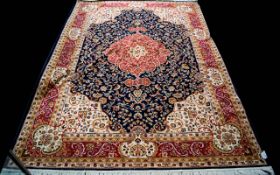 A Large Woven Silk Carpet Keshan carpet on blue ground with navy, red,