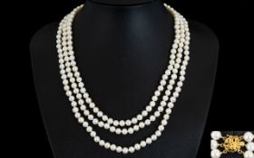 A Contemporary Cultured Pearl Triple Strand Necklace With 14ct Gold Ornate Clasp.