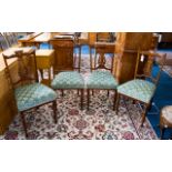 A Set Of Four Edwardian Mahogany Salon Chairs Each with carved inlaid back rests, padded seats and