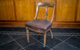 A 19th Century Carved Wood Dining Chair Carved headrest, upholstered in padded leather,