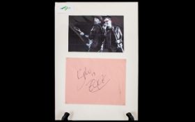U2 Autographs of Bono and The Edge displayed below a picture of the two singers.