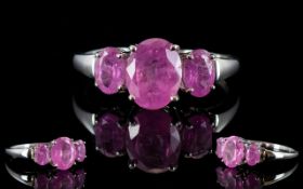 Pink Sapphire Three Stone Ring, a central oval cut pink sapphire of 2.
