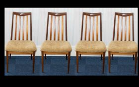A Set of Four G- Plan Spindle Back Dining Chairs of plain form.