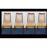 A Set of Four G- Plan Spindle Back Dining Chairs of plain form.