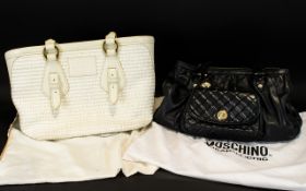 Two Designer Handbags, one Black Moschino, one cream The Bridge and both with original dust bags.