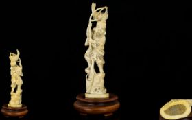 Japanese Late 19th Century Well Carved Ivory Figure of a Fisherman Standing on a Large Rock Holding