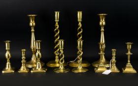 A large collection of Brass Candlesticks.