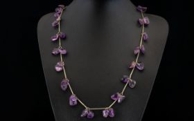 A Vintage Amethyst Necklace Long pewter tone necklace set with multiple,