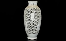 A Reticulated Oriental Lampstand Cream ceramic glazed ovoid lampstand with figural raised patterning