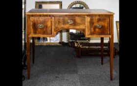 An Early 20th Century Knee Hole Desk Raised on square tapering legs with three drawers finished