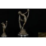 A Reproduction Art Deco Bronze Figure Raised on circular black marble plinth in the form of an