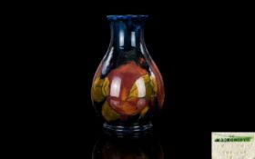 William Moorcroft Signed Small Baluster Shaped Vase ' Ochre Pomegranate ' on Blue Ground.
