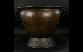 A Planished Metal Twin Handled Vessel.