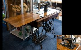 Antique Singer Sewing Machine on Stand of typical form. Finished in black and gilt. Height 29