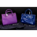 Two Armani Designer Handbags, one in blue and one in purple, both with original dust covers.