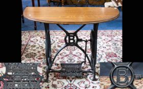 Converted Sewing Machine Console Table of typical form, demi lune top with cast iron base.