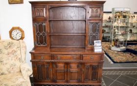 A Stained Beech Display Unit. Large display cabinet omprising three drawers above cupboard base,