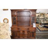 A Stained Beech Display Unit. Large display cabinet omprising three drawers above cupboard base,