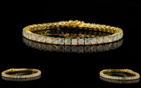 Opal Tennis Bracelet, a line of cushion cut opals, totalling 10cts,