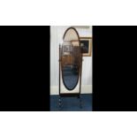 An Early 20thC Free Standing Bedroom Mahogany Framed Cheval Mirror of elegant oval form. Finial