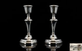 Elizabeth II Good Pair of Silver Candlesticks with Tapered Columns and Round Stepped Bases.