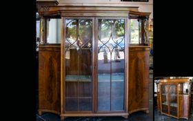 An Edwardian Display Cabinet with impressive glazed sectional doors with two internal shelves,