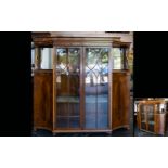 An Edwardian Display Cabinet with impressive glazed sectional doors with two internal shelves,