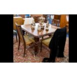 Dining Table of Square Form (rectangular when extended) with carved pilaster legs on castors.