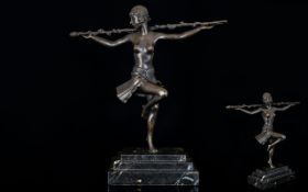 A Reproduction Art Deco Bronze Female Figure Raised on a graduated rectangular black marble plinth.