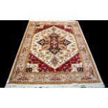 A Large Woven Silk Heriz Carpet Finley woven rug on beige ground with intricate scrolling floral