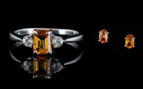 Orange Sapphire Ring and Pair of Stud Earrings, an octagon cut orange sapphire of 1ct,