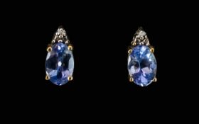 Tanzanite And Diamond Stud Earrings Each stud mounted with oval cut .