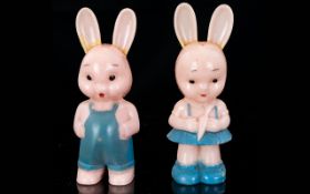 A Pair Of Vintage Early Plastic Figures/Infants Rattles By Kleeware England Two hard plastic figures