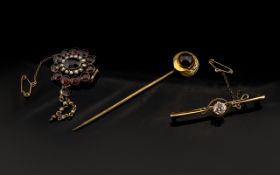 A 19th Century Adapted Brooch Contains a central garnet surrounded by seed pearls and further