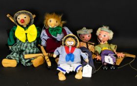 A Collection Of Wooden Puppets Five In Total. Two Pelham Puppets And Three Wooden Clown Marionettes.