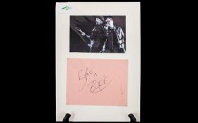 U2 Autographs of Bono and The Edge displayed below a picture of the two singers.