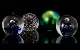 A Collection of Glass Paperweights (4) in total. To include two blue swirl effect, one bubble effect