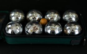 A Set of French Boules in a green canvas carry bag.