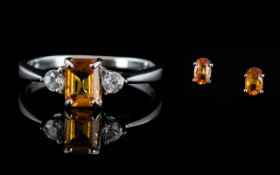 Orange Sapphire Ring and Pair of Stud Earrings, an octagon cut orange sapphire of 1ct, flanked by