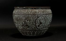 A 19th Century Middle Eastern Brass Jardiniere with embossed decoration depicting deity's and