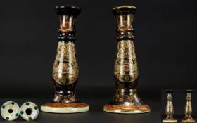 A Pair of Oriental Candlesticks two earthenware candlesticks of pillar form,