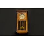 A 1930's Wall Mounted Clock In rectangular glazed case, Of typical form with brass dial.